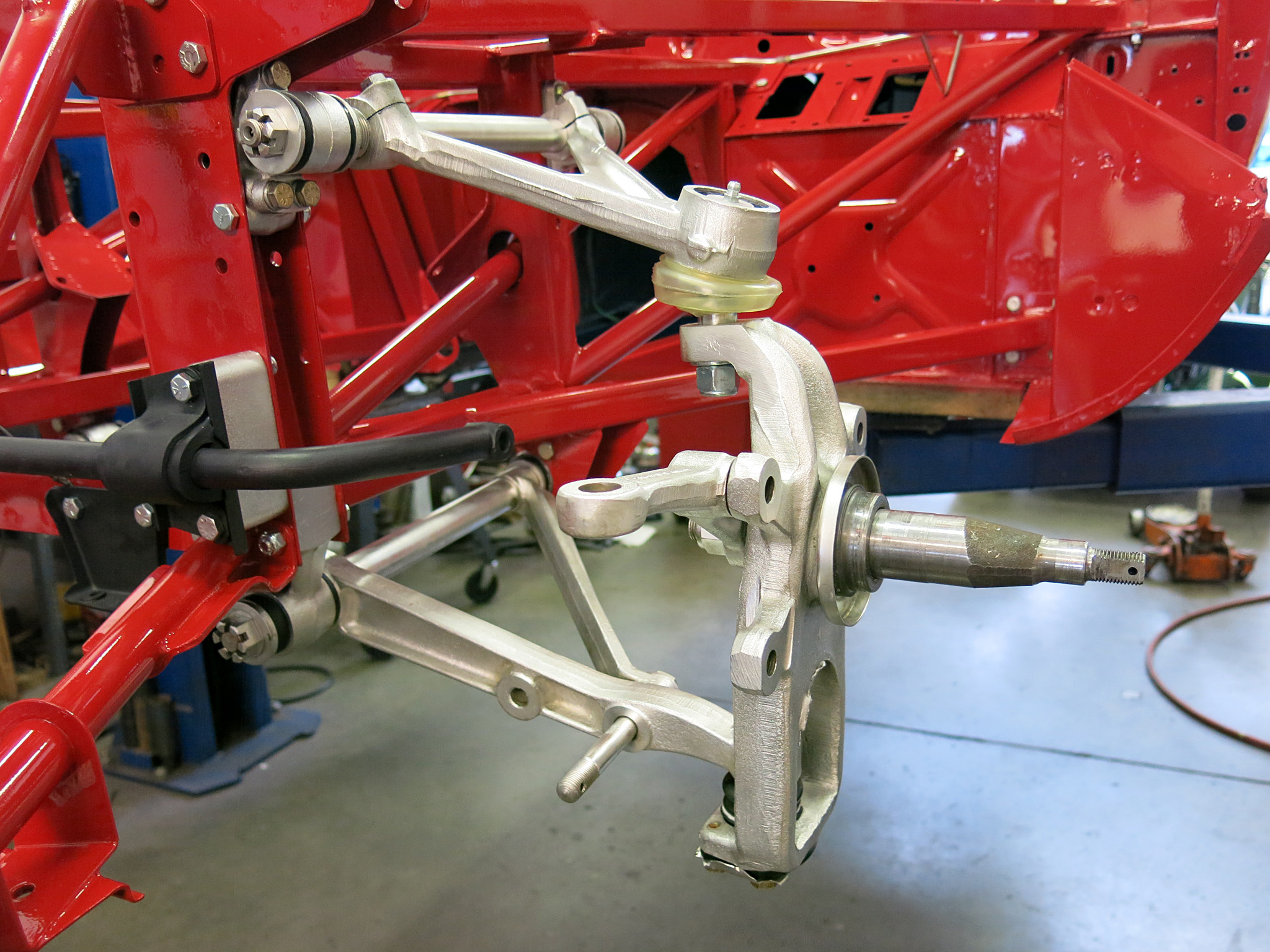 Nice image showing the plated control arms and stub axle carrier.